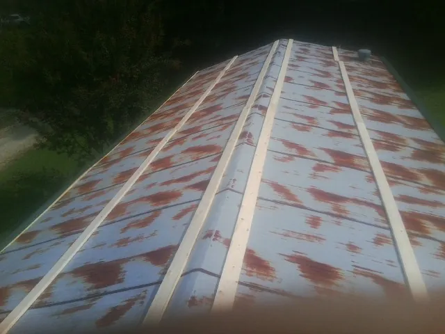 Rusted metal roof panels with new wood purlins before replacement — Storm Damage Roof Repair in Joppa by Roofing Brothers