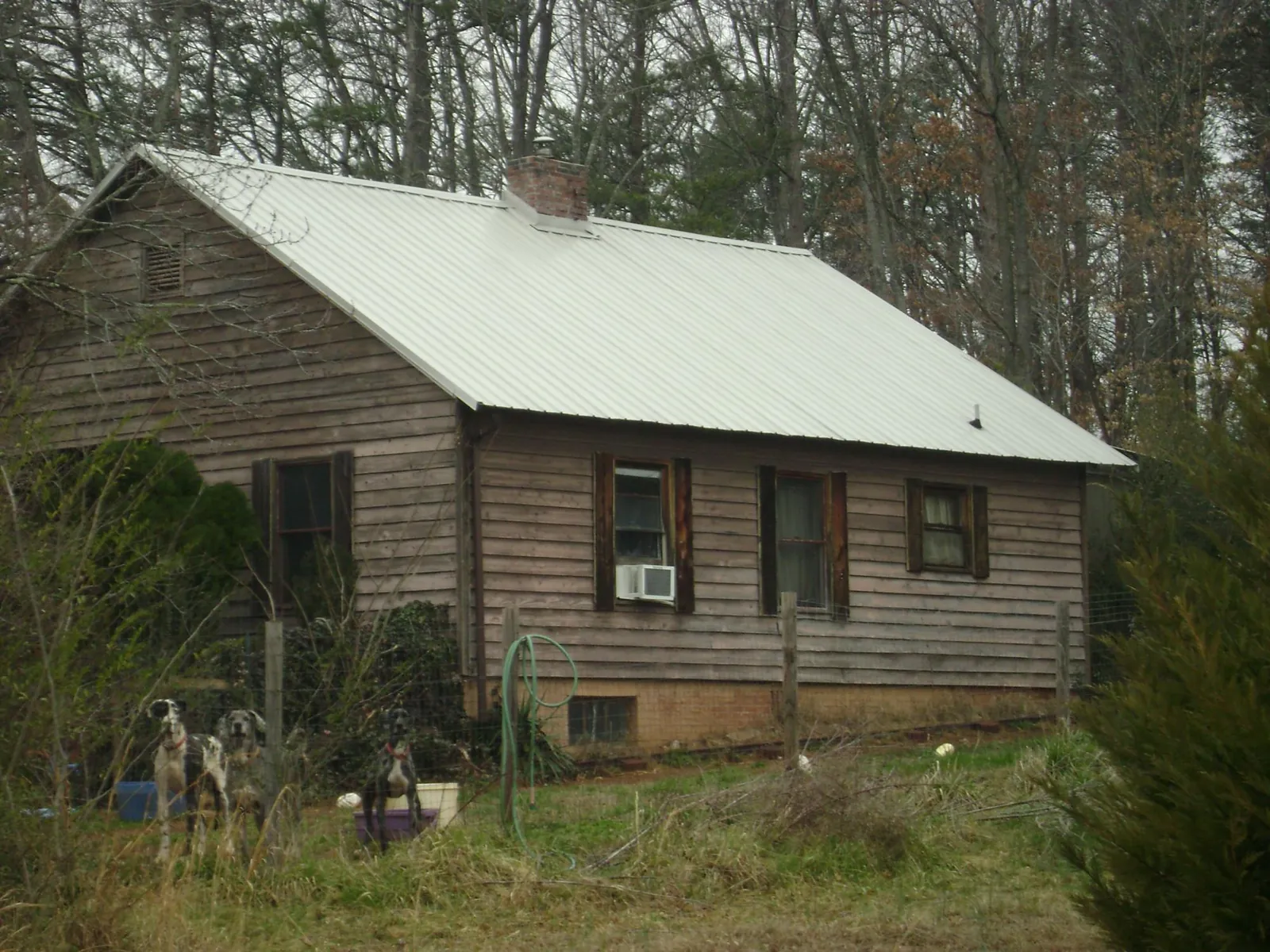 White metal roof on an old wood sided farmhouse, from a Metal Roof Installation job in Joppa